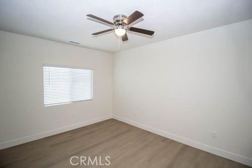 unfurnished room featuring hardwood / wood-style floors and ceiling fan