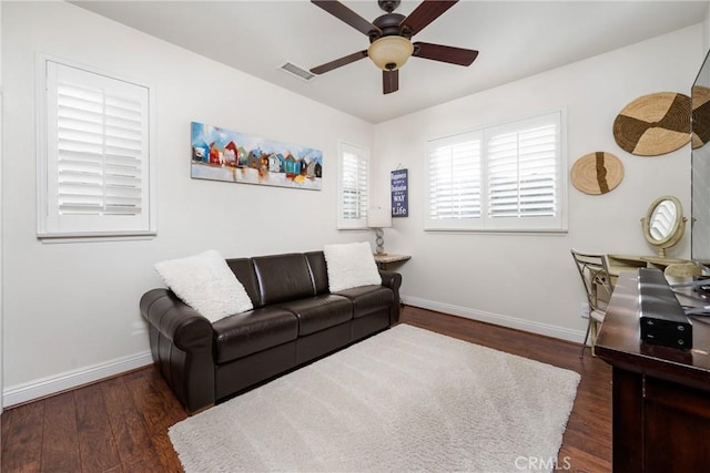 living room featuring ceiling fan and dark hardwood / wood-style flooring