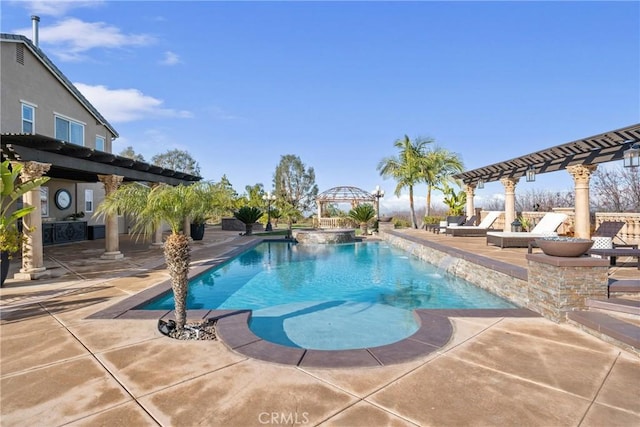 view of swimming pool with a patio area and an in ground hot tub