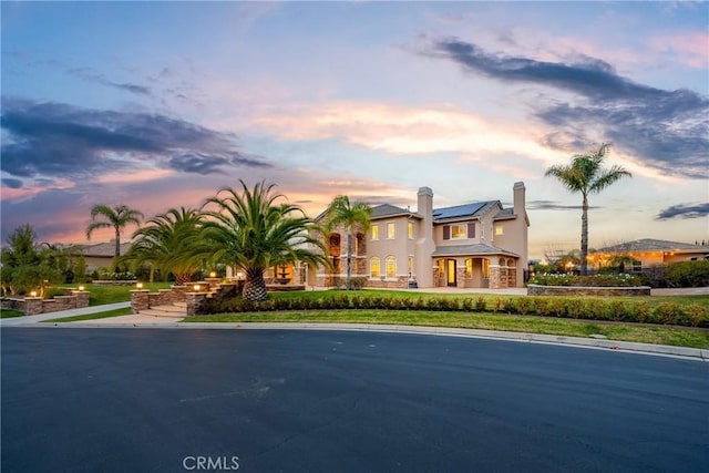 mediterranean / spanish-style home featuring solar panels