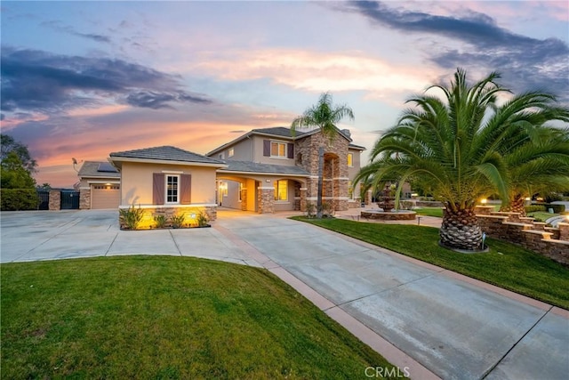 view of front of property with a garage and a lawn