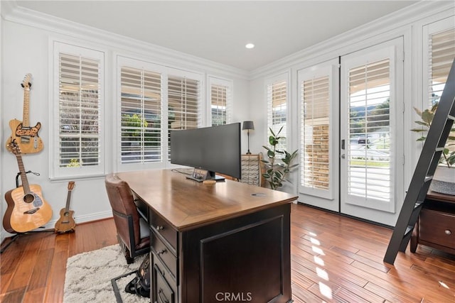 home office featuring crown molding and light hardwood / wood-style floors