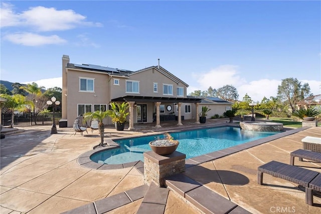 view of swimming pool with a patio and an in ground hot tub