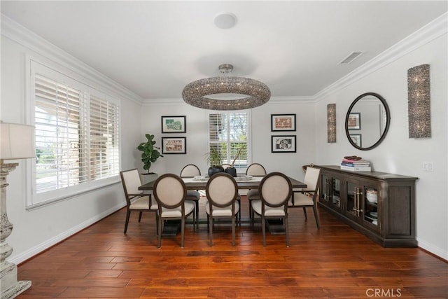 dining area featuring dark wood-type flooring and ornamental molding