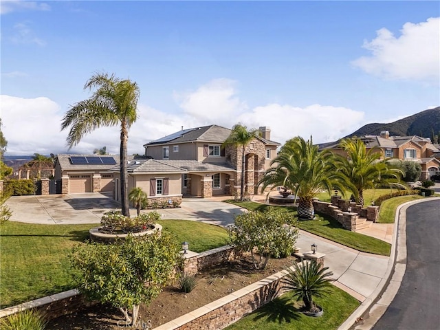 view of front of home featuring a front yard and solar panels