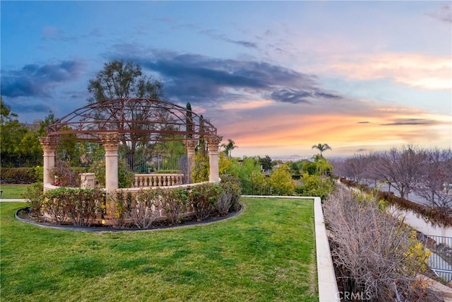 yard at dusk with a gazebo