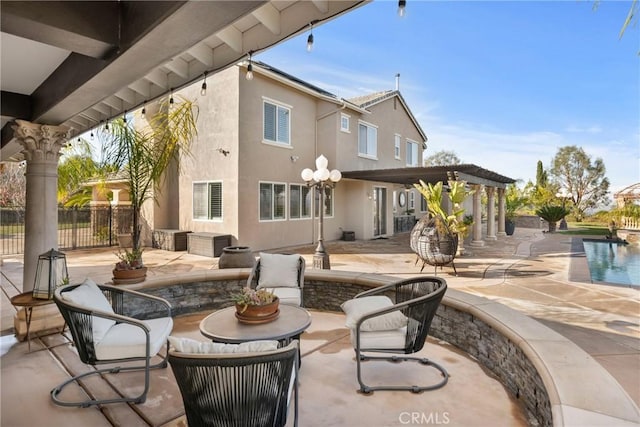 rear view of property featuring a fenced in pool, a patio area, and a pergola