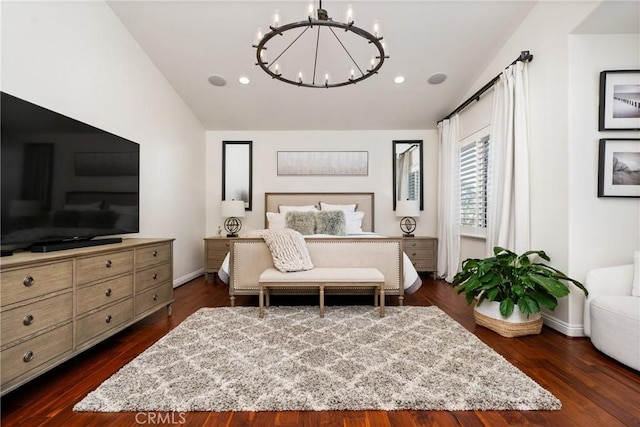 bedroom featuring dark hardwood / wood-style flooring, vaulted ceiling, and a chandelier