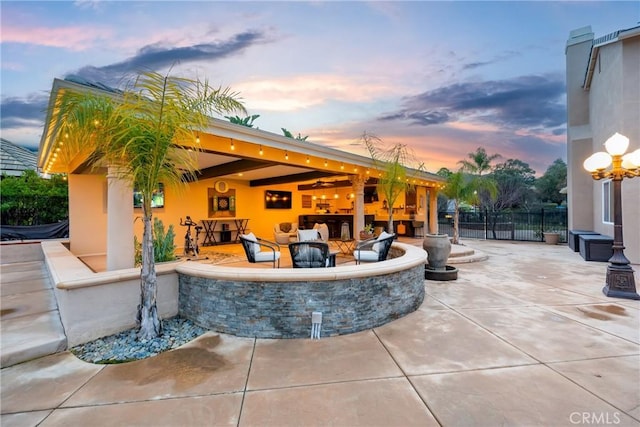 view of patio terrace at dusk