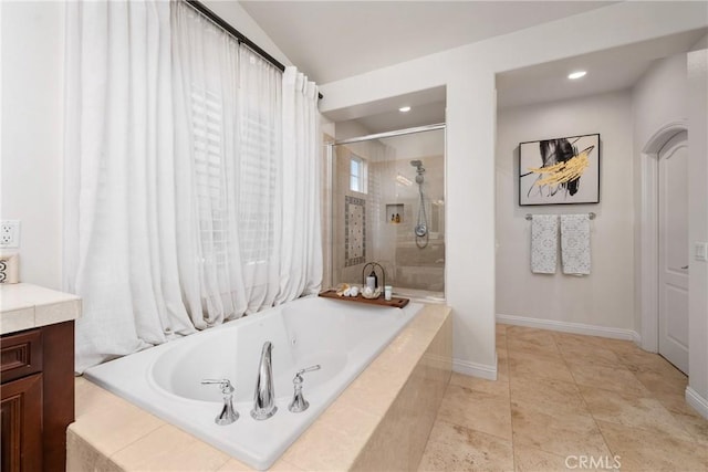 bathroom featuring vanity, tile patterned floors, and plus walk in shower