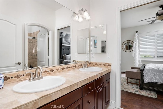 bathroom with hardwood / wood-style flooring, ceiling fan, and vanity