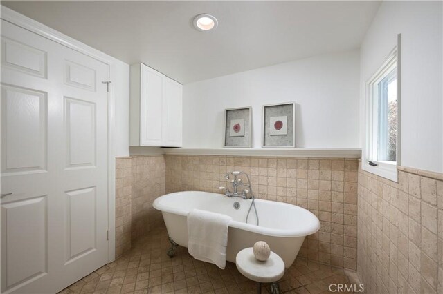 2130 Glenneyre St, Laguna Beach, CA 92651 - bathroom with tile walls, a freestanding tub, wainscoting, recessed lighting, and tile patterned floors