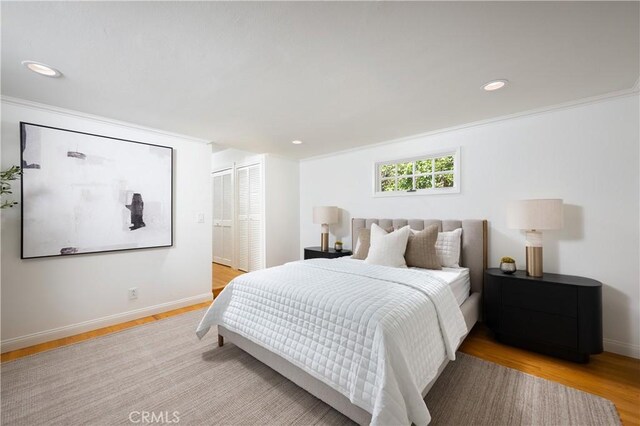 2130 Glenneyre St, Laguna Beach, CA 92651 - bedroom with light wood-type flooring, a closet, recessed lighting, baseboards, and ornamental molding