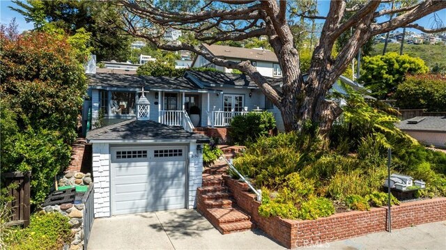 2130 Glenneyre St, Laguna Beach, CA 92651 - view of front facade featuring concrete driveway and a detached garage