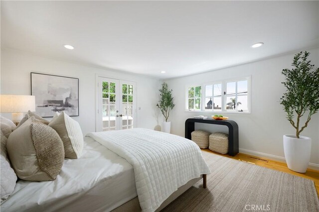 2130 Glenneyre St, Laguna Beach, CA 92651 - bedroom with multiple windows, french doors, wood finished floors, recessed lighting, and baseboards