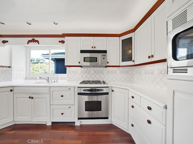 931 Gardenia Way, Corona Del Mar, CA 92625 - kitchen with dark wood finished floors, light countertops, white cabinets, and stainless steel appliances