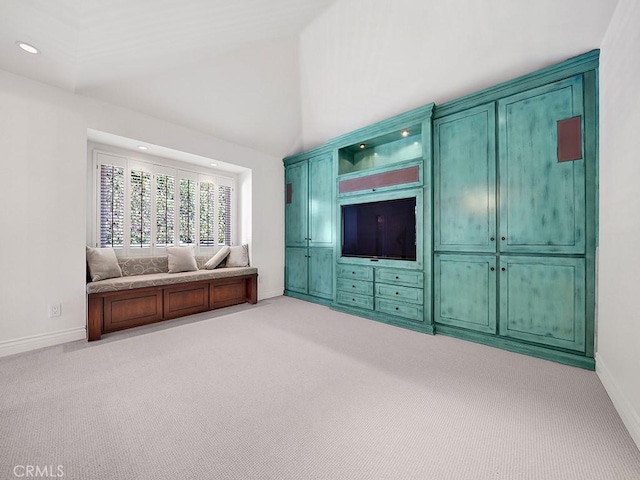 unfurnished living room featuring light carpet, recessed lighting, high vaulted ceiling, and baseboards