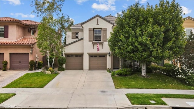 view of front of home with a front lawn and a garage