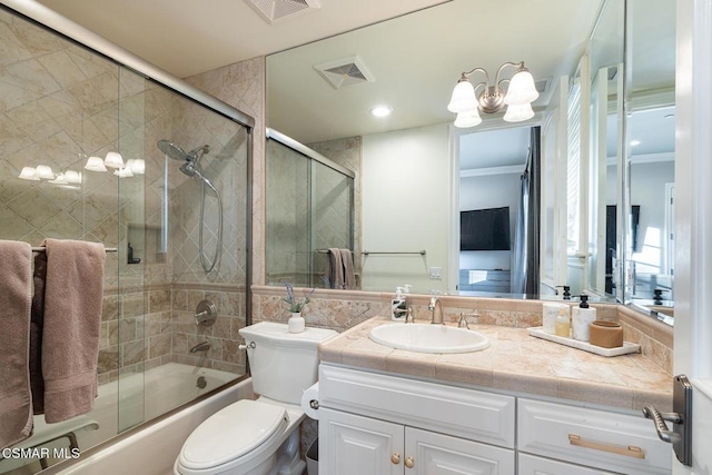 full bathroom featuring ornamental molding, vanity, toilet, and combined bath / shower with glass door