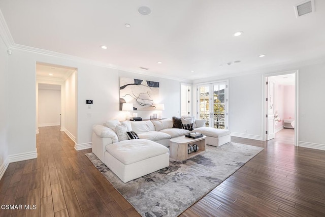 living room featuring ornamental molding and dark hardwood / wood-style floors