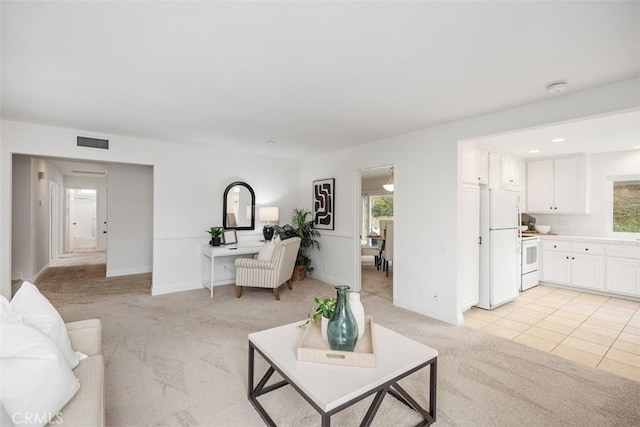 carpeted living room with a wealth of natural light