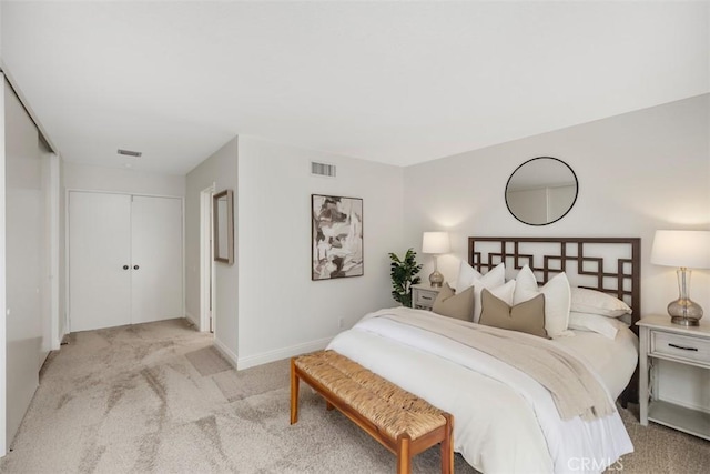 bedroom featuring light carpet and a closet