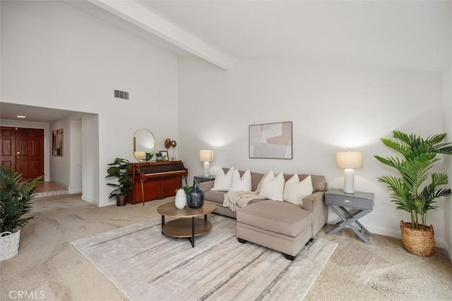 carpeted living room with beam ceiling and high vaulted ceiling