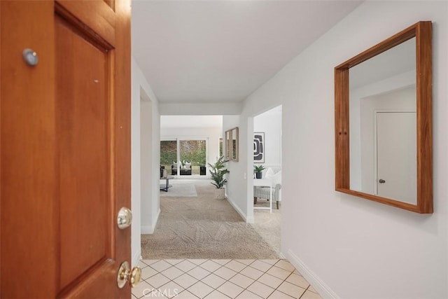 hallway featuring light colored carpet