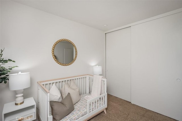 carpeted bedroom featuring a closet