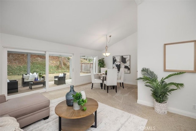 living room featuring high vaulted ceiling and light colored carpet