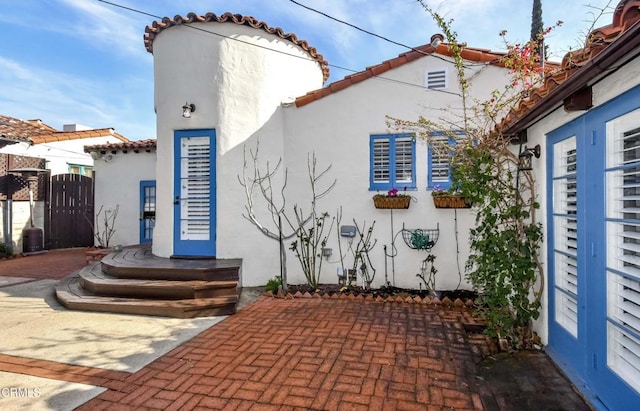 back of property with a patio area and french doors