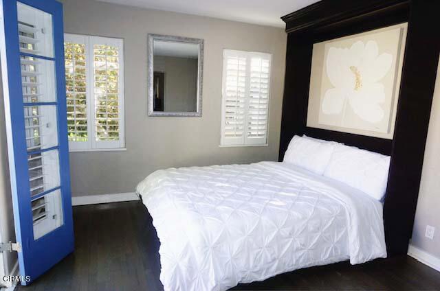 bedroom with dark hardwood / wood-style flooring