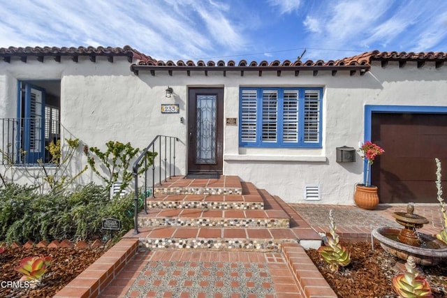 property entrance with crawl space and stucco siding