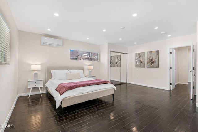 bedroom with dark hardwood / wood-style flooring, a wall mounted air conditioner, and a closet