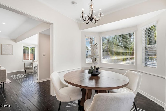 dining area featuring dark wood-type flooring and a chandelier