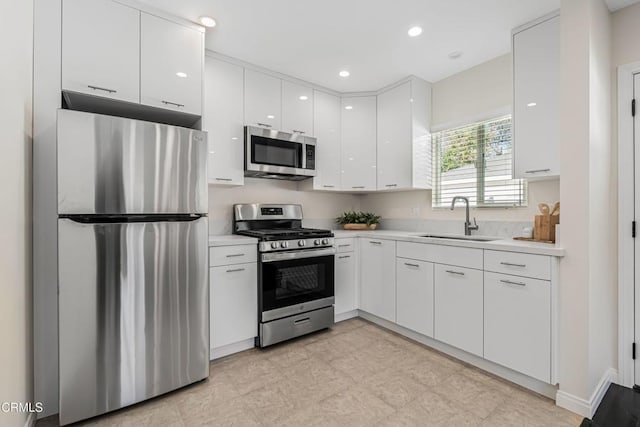 kitchen featuring white cabinetry, appliances with stainless steel finishes, and sink