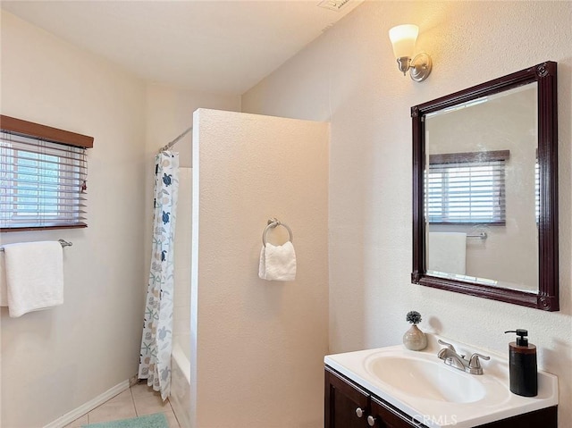 bathroom with tile patterned flooring, vanity, and shower / bath combo