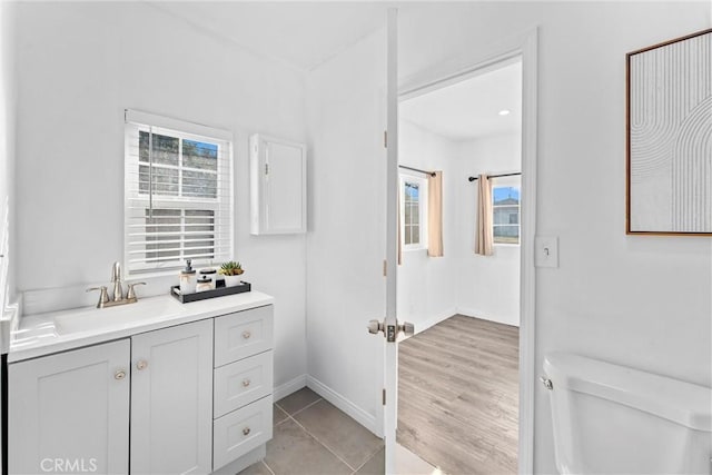 bathroom with vanity, toilet, and tile patterned flooring