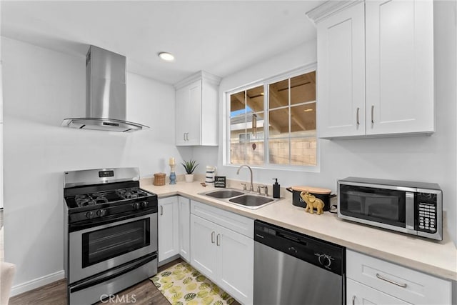 kitchen with sink, stainless steel appliances, extractor fan, wood-type flooring, and white cabinets