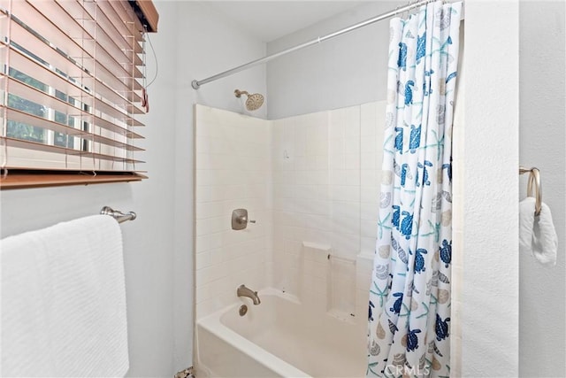 bathroom featuring shower / tub combo with curtain