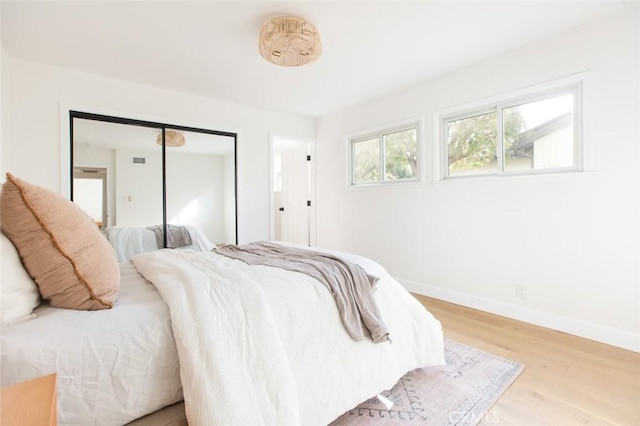 bedroom featuring hardwood / wood-style flooring and a closet