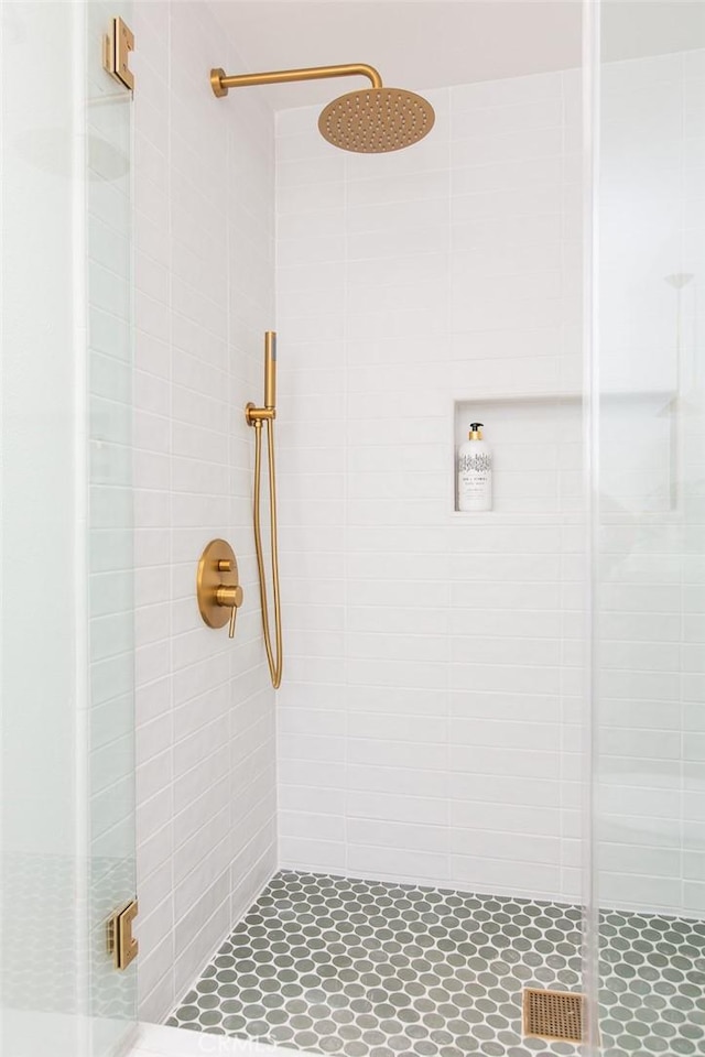 bathroom featuring a shower with shower door