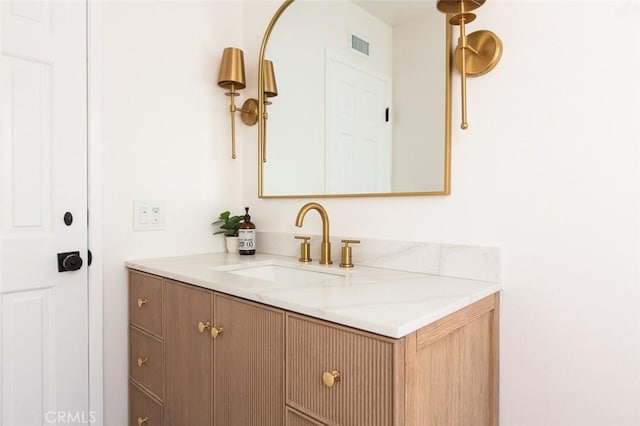 bathroom with vanity and visible vents