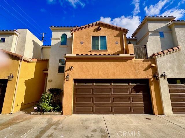 mediterranean / spanish-style home with a garage