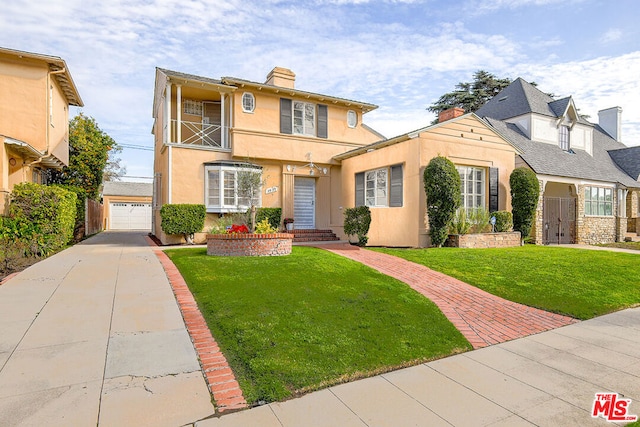 front of property with a garage, a front lawn, and a balcony