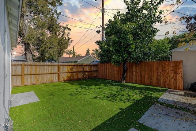 view of yard with a fenced backyard