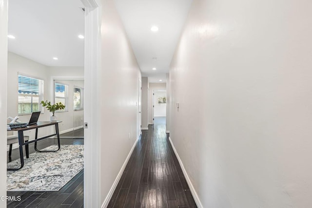 hall with dark wood-style floors, recessed lighting, and baseboards