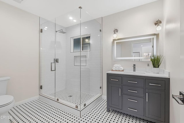 full bath featuring a shower stall, baseboards, toilet, tile patterned floors, and vanity