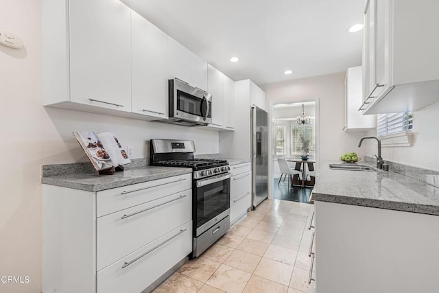 kitchen with white cabinetry, recessed lighting, appliances with stainless steel finishes, and a sink