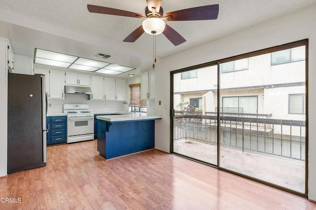 kitchen featuring stainless steel refrigerator, sink, white cabinets, white gas range oven, and light hardwood / wood-style flooring